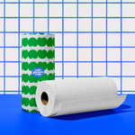Two rolls of Who Gives a Crap paper towel against blue and white background