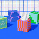 Four boxes of of Who Gives a Crap recycled tissues against blue and white bathroom wall