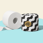 Two rolls of Who Gives a Crap bamboo toilet paper against a blue and beige background.