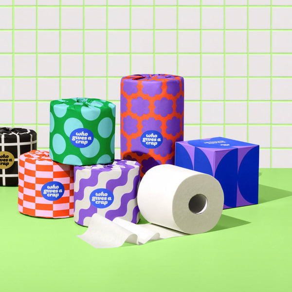 Who Gives a Crap recycled and bamboo toilet paper alongside a box of tissues and paper towel.
