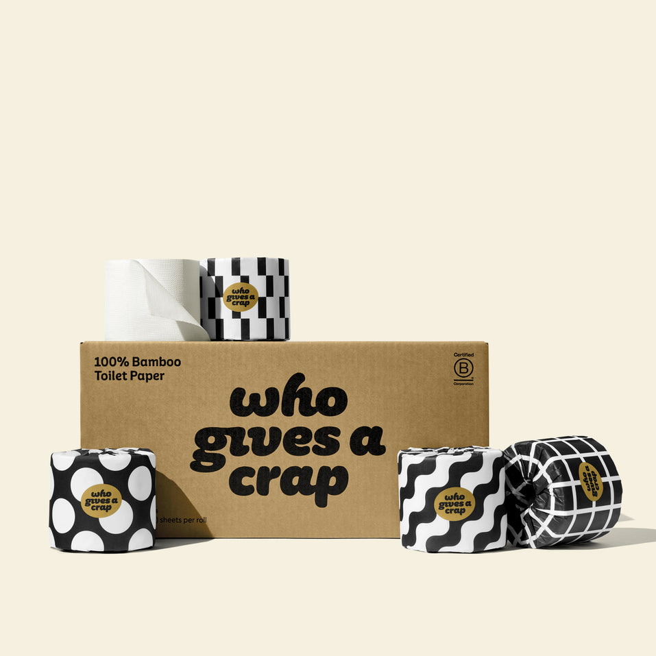 A medium box of Who Gives A Crap 100% Bamboo Toilet Paper with black and white wrappers - eco-friendly, biodegradable and sustainable toilet paper