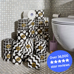 Several rolls of wrapped and unwrapped Premium Toilet Paper sits on the bathroom floor next to a toilet. Copy over the image reads ‘Over 36,000 5 star reviews’.