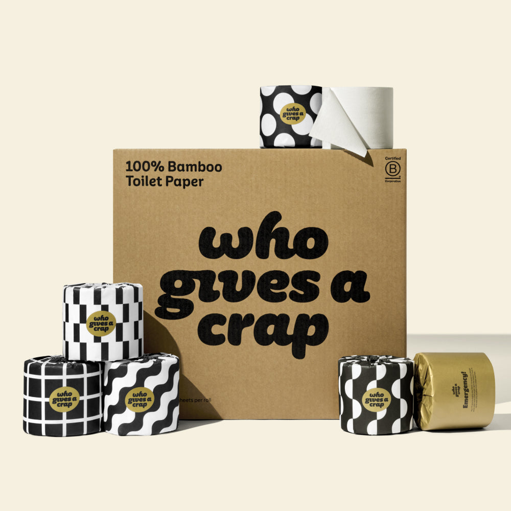 A large box of Who Gives A Crap 100% Bamboo Toilet Paper with black and white wrappers - eco-friendly, biodegradable and sustainable toilet paper.