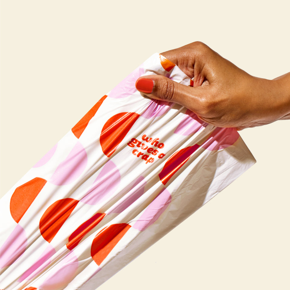 Hand pulling a trash bag, highlighting the strength and durability of the bag.