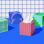 Four boxes of of Who Gives a Crap recycled tissues against blue and while bathroom wall