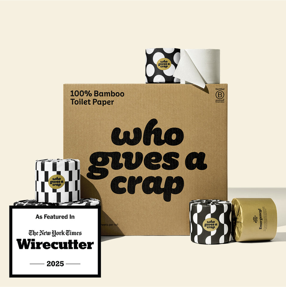 A large box of Who Gives A Crap 100% Bamboo Toilet Paper with black and white wrappers - eco-friendly, biodegradable and sustainable toilet paper. There is a badge stating 