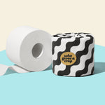 Two rolls of Who Gives a Crap bamboo toilet paper against a blue and beige background.