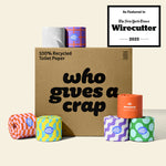 A large box of Who Gives A Crap 100% Recycled Toilet Paper with colorful wrappers - eco-friendly, biodegradable and sustainable toilet paper. Displays a badge stating 