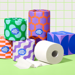 Bundle of Who Gives a Crap products with recycled toilet paper, paper towel and tissues against green and white background