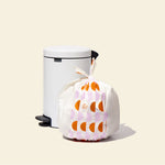 Who Gives a Crap large recycled trash bag sits full next to kitchen bin
